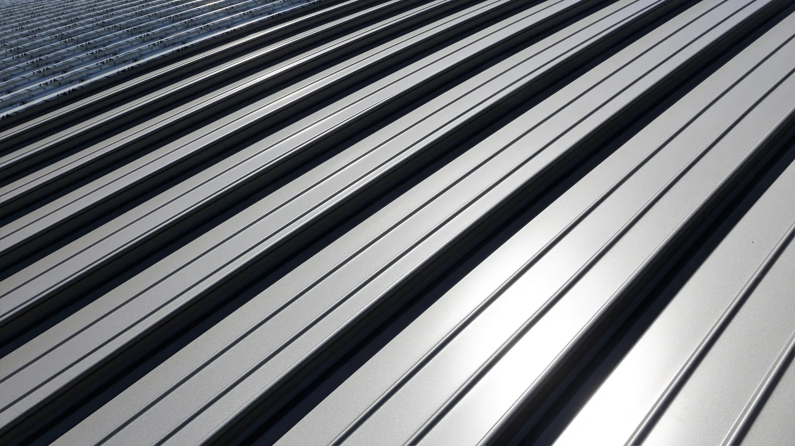 Sunlight reflecting off standing seam metal roof panels